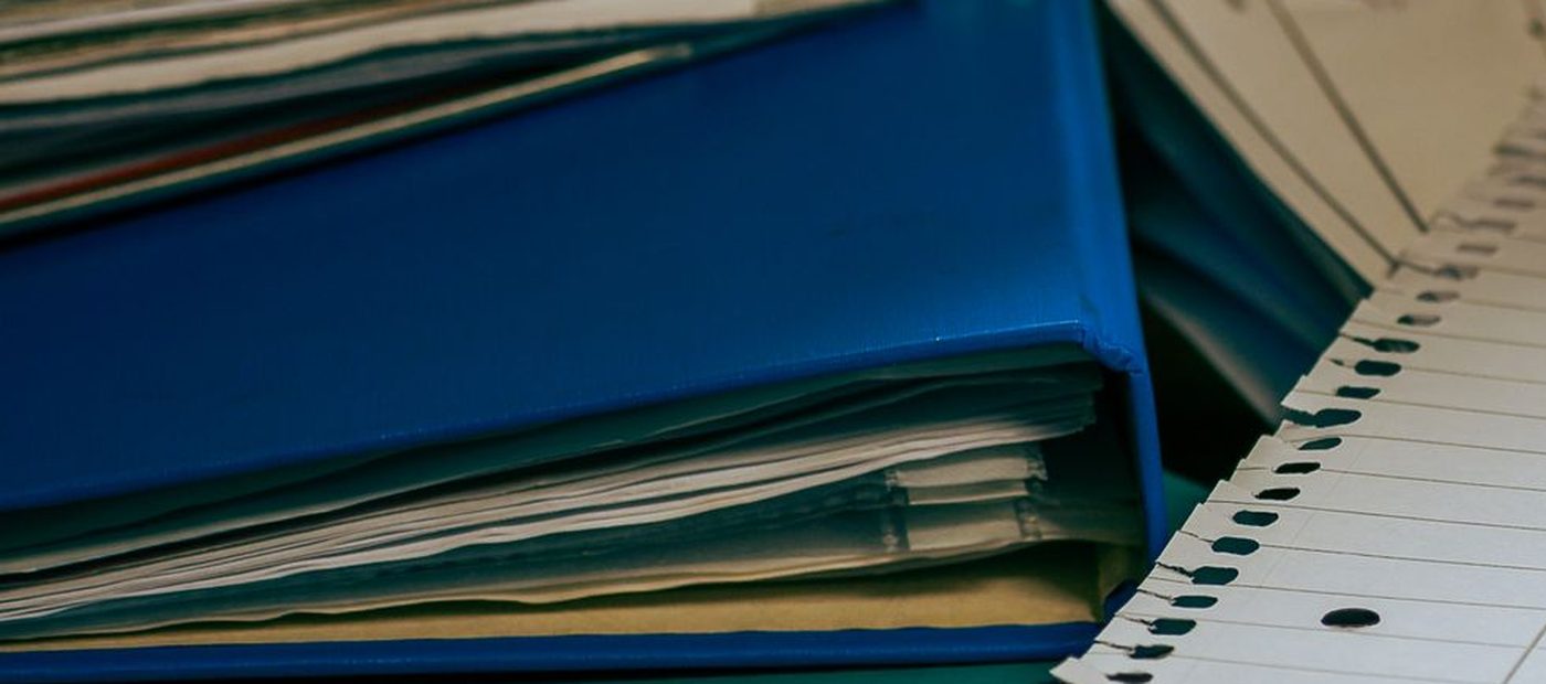 A bound file of accounting papers on a desk