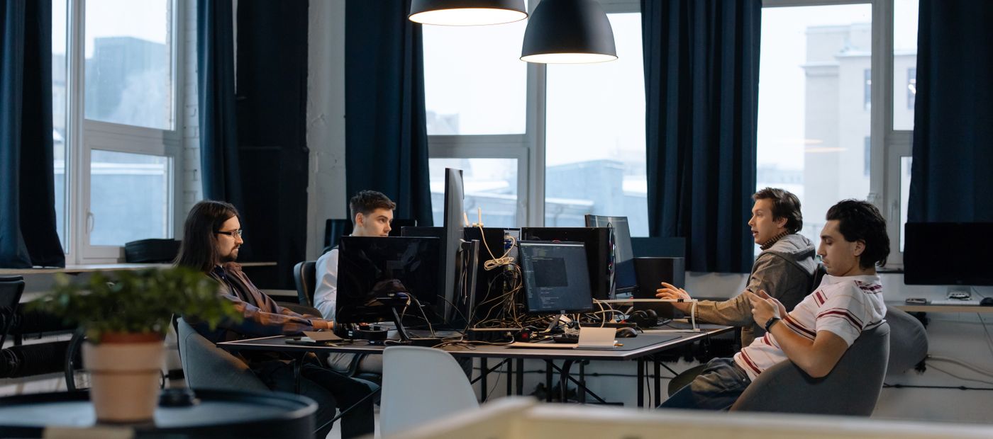 A team working together at computer stations in a modern office