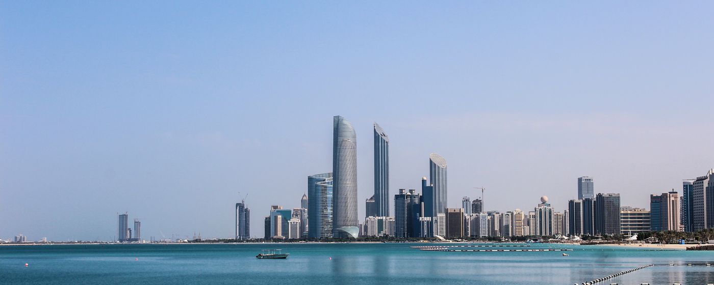 The Abu Dhabi skyline reflected in the Gulf on a sunny day