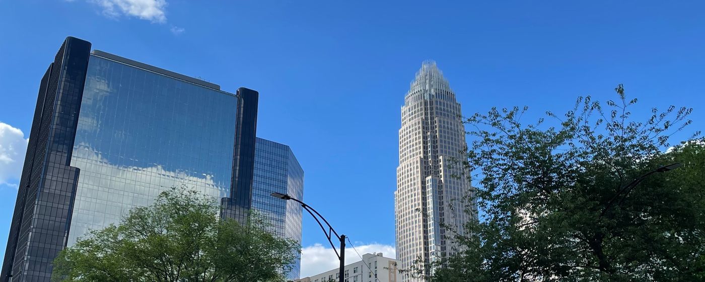 The Charlotte skyline under a clear blue sky