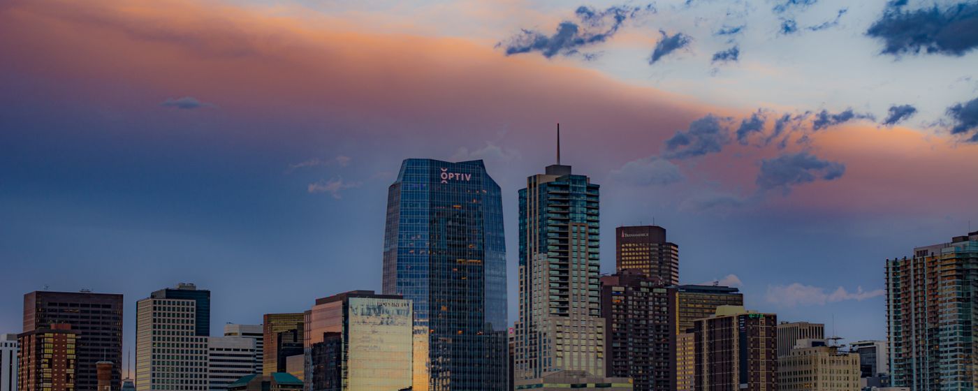 The Denver cityscape under a colourful sunset sky