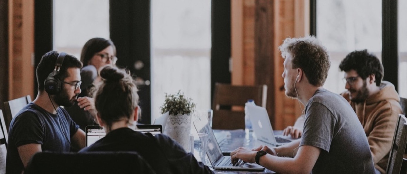 Two people talking across a desk