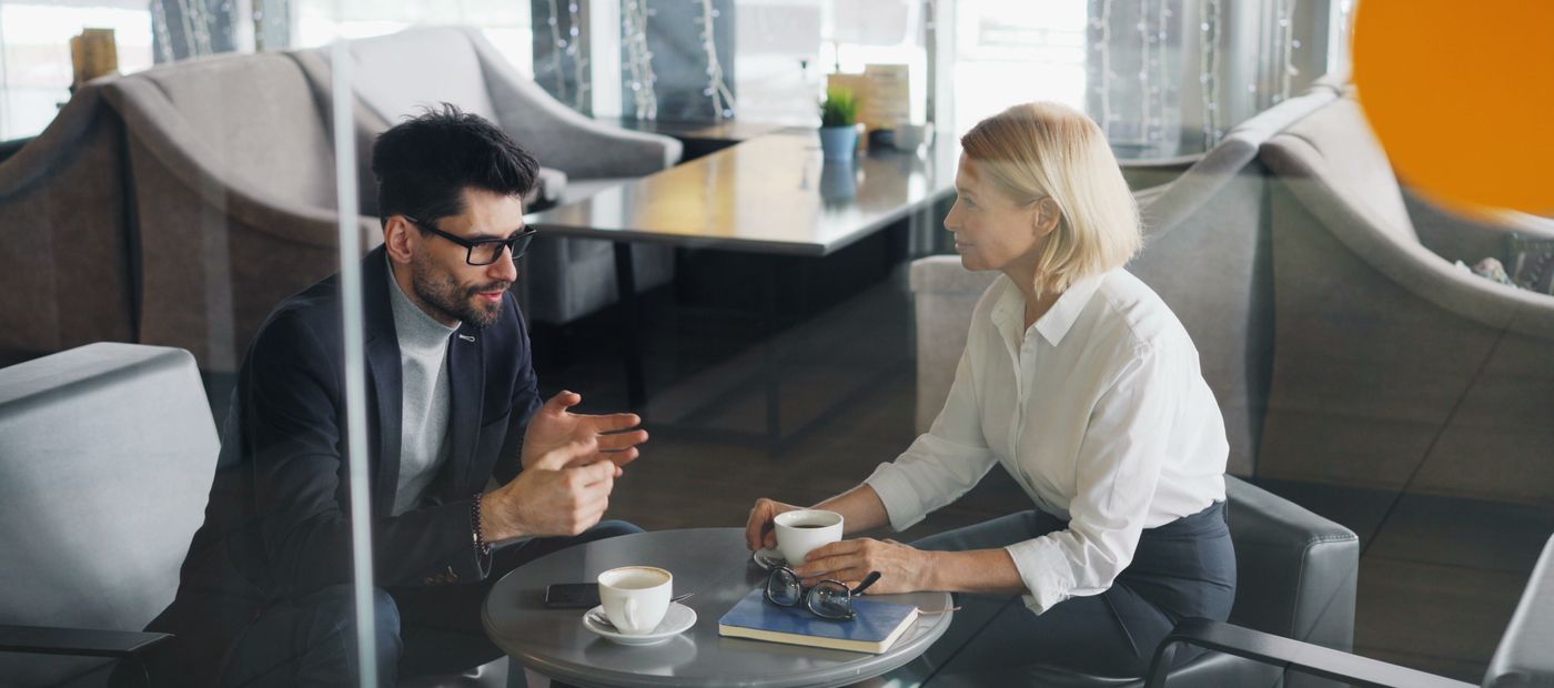 Two people in discussion in a modern office