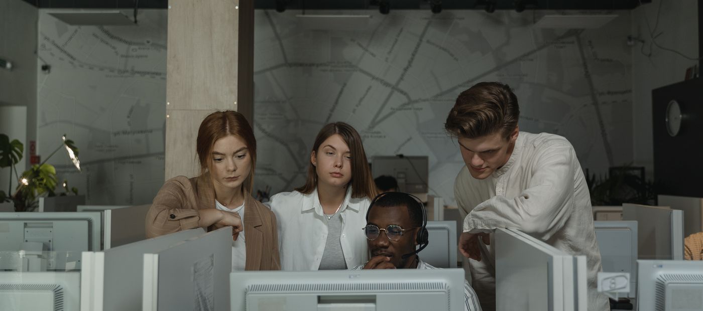 A team working together at computer stations in an office