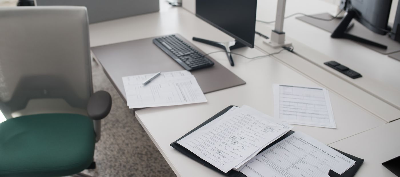 An organized desk with documents and a laptop