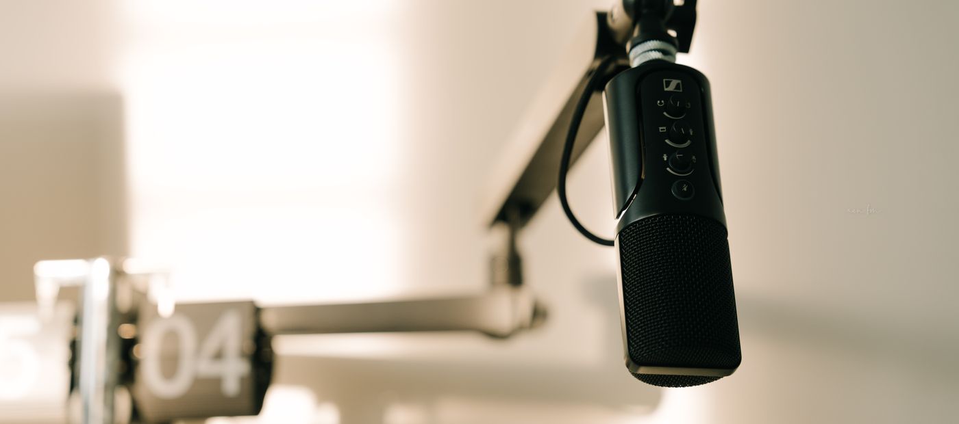 A studio microphone on a boom arm