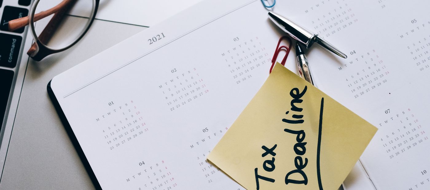 A desk calendar with a deadline marked and documents beside it
