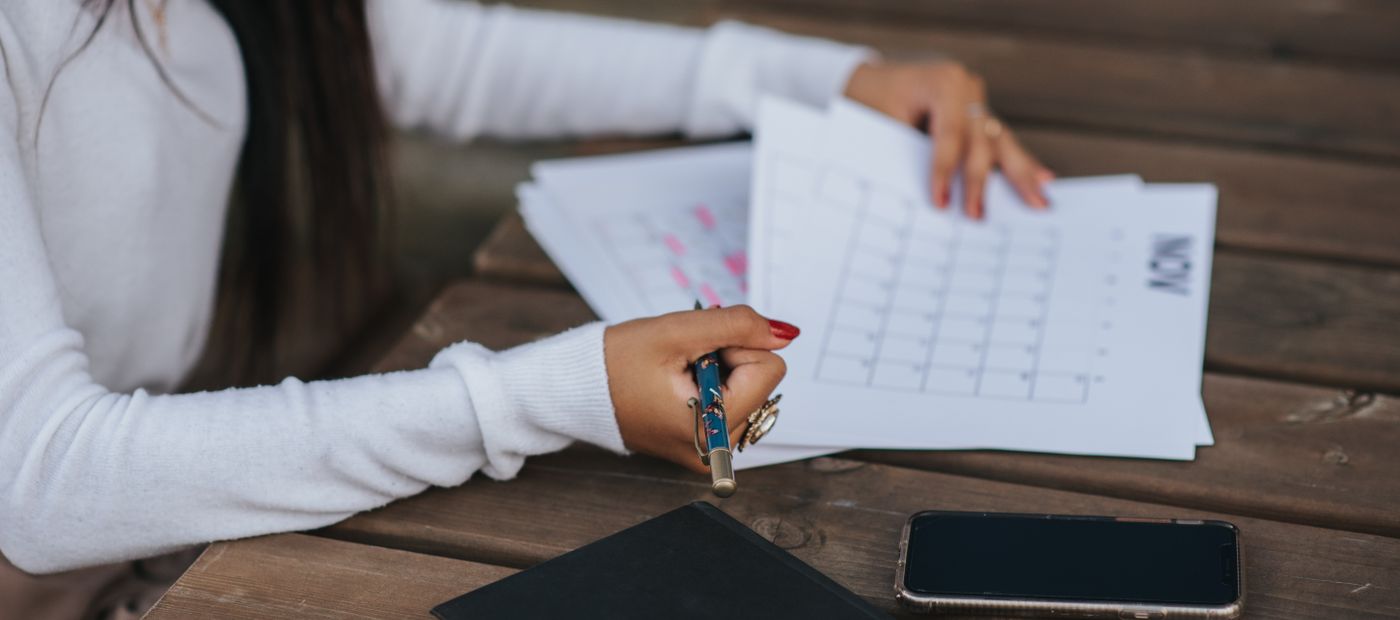 A desk calendar and a phone, somebody working out which day to call back