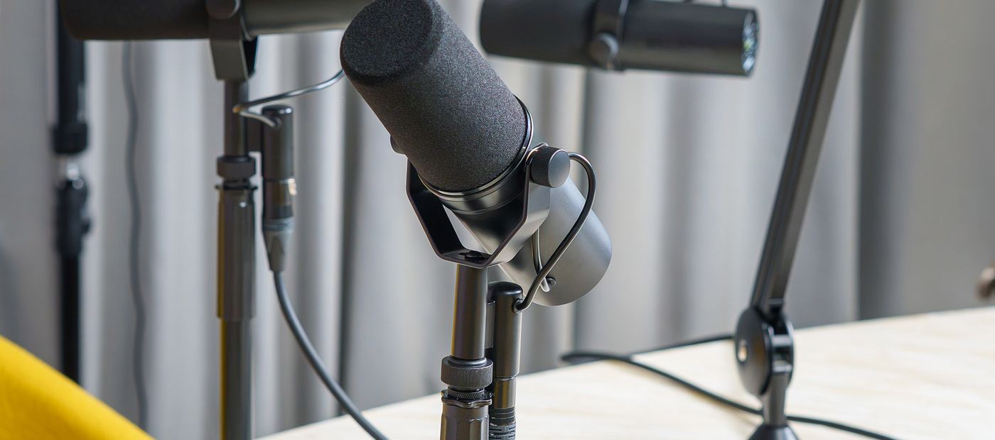 Microphones set up in a podcast studio ready to record