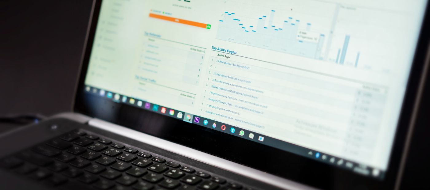 A laptop showing an analytics dashboard tracking site traffic